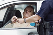 Police sergeant checking driver's license.