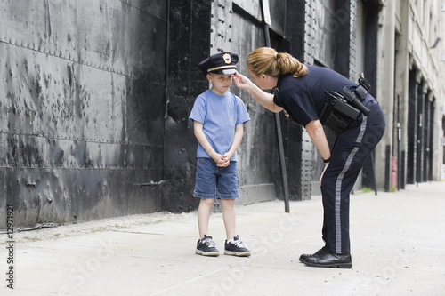 Photo: Woman police officer talking to a boy. Woman police officer talking to a boy.