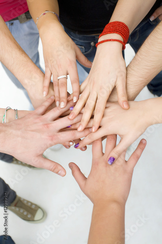 Photo: hands on top of each other; teamwork concept hands on top of each other; teamwork concept