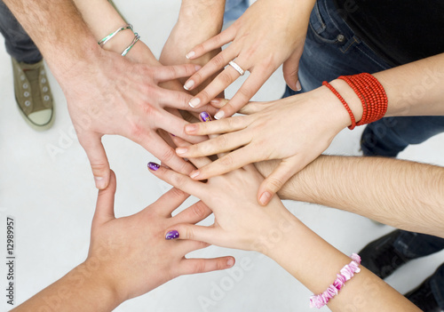 Photo: hands on top of each other; friendship concept hands on top of each other; friendship concept