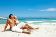 Photo: A beautiful couple relaxing at the sea shore A beautiful couple relaxing at the sea shore