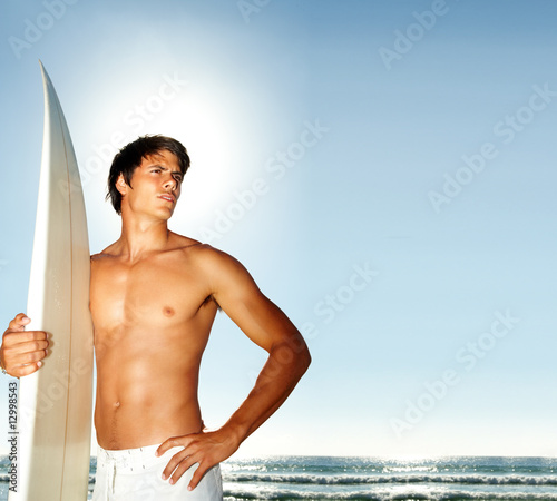 Photo: A strong young man with a surfboard A strong young man with a surfboard