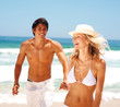 Photo: Attractive young couple having fun at the beach Attractive young couple having fun at the beach