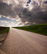 Photo: Rural road on horizon stormy clouds Rural road on horizon stormy clouds