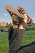 Resting Young Woman Feet in Sunny Outdoor and Blue Sky Resting Young Woman Feet in Sunny Outdoor and Blue Sky
