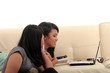 two young woman on sofa