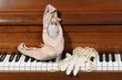 Lace glove and pearls on piano keys