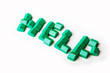Model plastic houses/homes forming the word HELP.