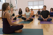 Teacher guides student in yoga class Teacher guides student in yoga class