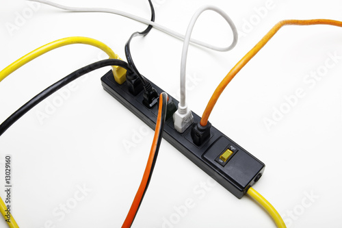 Photo: Power cords plug into a surge protector Power cords plug into a surge protector