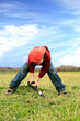 Boy digging on the meadow.