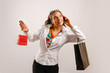 Photo: Beautiful young woman talking at the phone and holding Beautiful young woman talking at the phone and holding