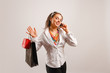 Photo: Beautiful young woman talking at the phone and holding Beautiful young woman talking at the phone and holding