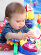 Foto: Cute baby with blue eyes playing in his walker Cute baby with blue eyes playing in his walker