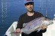 Fisherman showing proud catch saltwater fish
