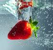 Strawberry falling in water