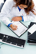 Photo: high angle view of doctor writing prescription high angle view of doctor writing prescription