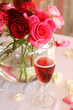 Bouquet of roses and glass of champagne