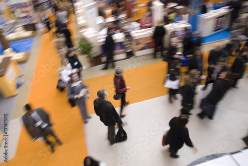Photo: Visitors passing by stands at exhibition Visitors passing by stands at exhibition