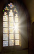 Church stained-glass window with light shining through Church stained-glass window with light shining through