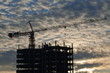 The elevating crane on ripped clouds background