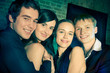 Two young attractive smiling couples or friends at party Two young attractive smiling couples or friends at party