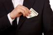Business man put money in his pocket