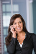 Business woman on a cell phone in a modern office Business woman on a cell phone in a modern office