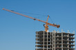 The elevating crane on clear blue sky background