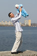 father and his son are walking at the river