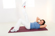 Elder woman working out on mat