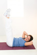 Elder woman working out on mat