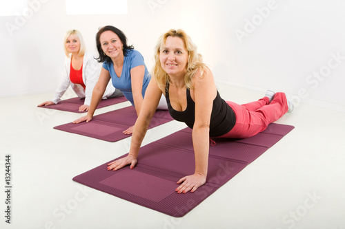 Photo: Women doing exercices on mat Women doing exercices on mat