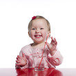 Happy toddler with glass of water
