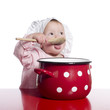 Toddler pretending to cook with a big red pot.