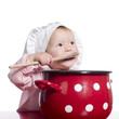 Toddler pretending to cook with a big red pot.