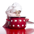 Toddler pretending to cook with a big red pot.