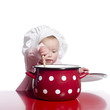 Toddler pretending to cook with a big red pot.