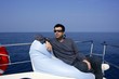Man on bow boat relaxed on bean bag