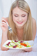 Pretty smiled woman with salad