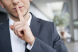 mann in anzug legt finger auf lippen
