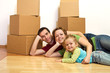 Happy family laying on the floor in their new home