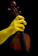 violin and hand in yellow plastic glove