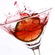 red cocktail with lime on white