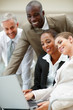 Group of business colleagues working on a laptop