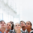 Group of business colleagues looking upwards at copyspace