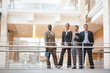 Successful business people standing by a railing