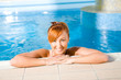 Young happy woman in pool