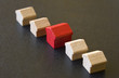 Five wooden houses  from “Monopoly” on dark background
