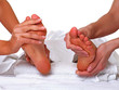 Four hands do massage to two female feet